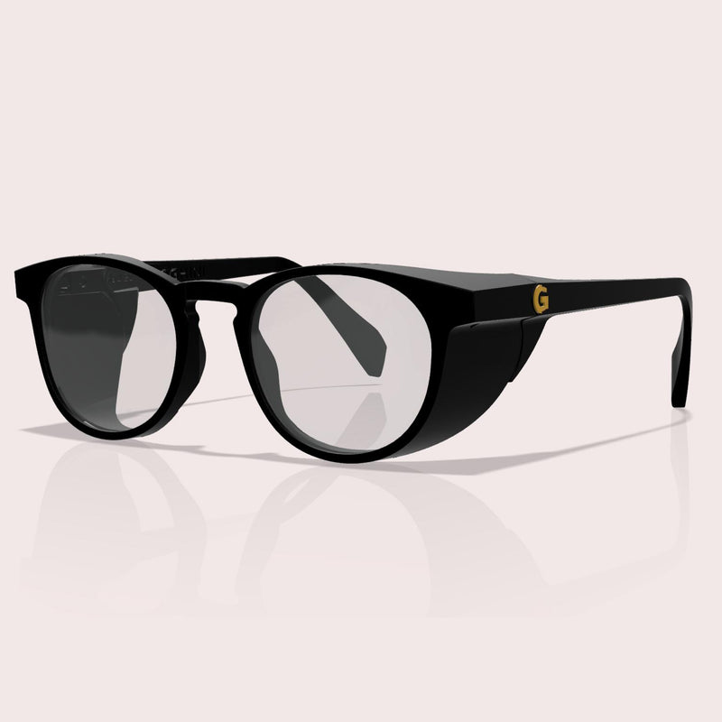 GOGHINI Focus Frames™ shown from front three-quarter angle, displaying black round frames with integrated side shields for peripheral vision blocking, featuring yellow 'G' logo on the temple