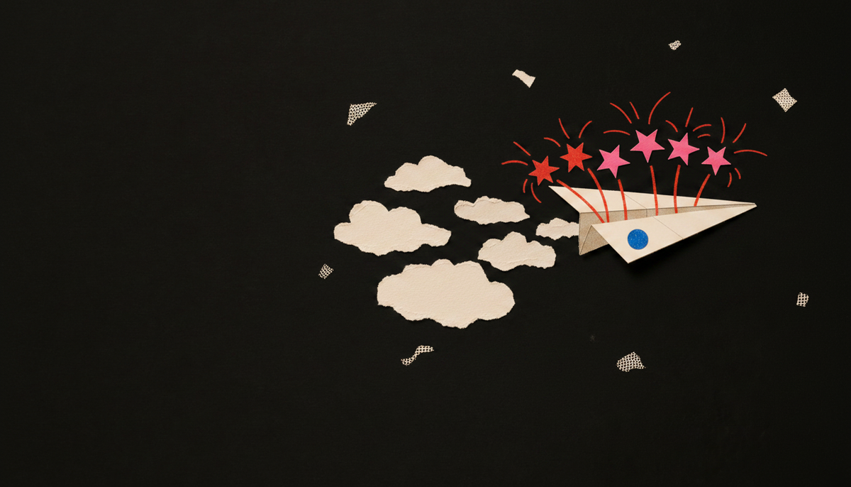 Tactile paper collage of a cream paper plane trailing torn clouds while red and pink starbursts erupt above it