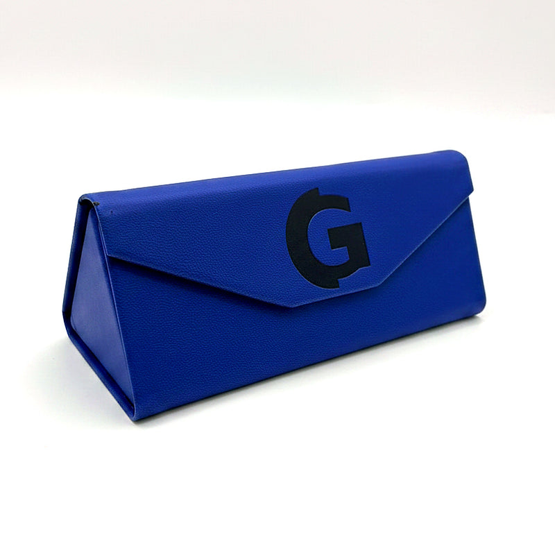 Cobalt blue GOGHINI fold-up glasses case closed, envelope flap with navy G monogram