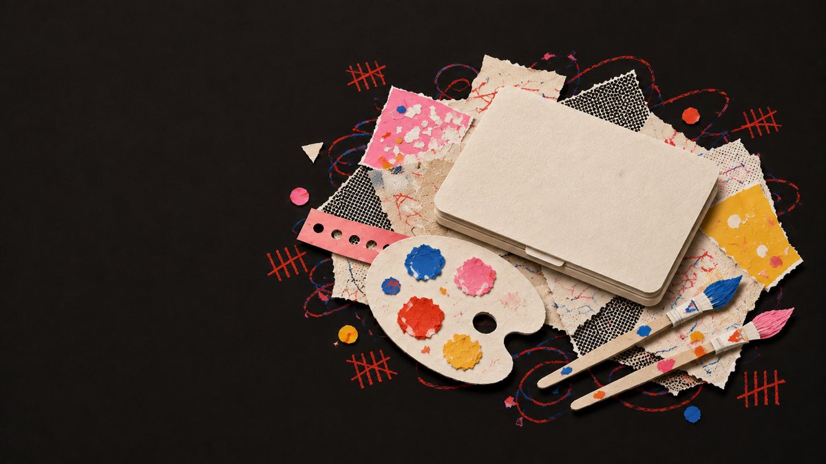 Paper collage of a closed laptop and paintbrushes beside a palette.