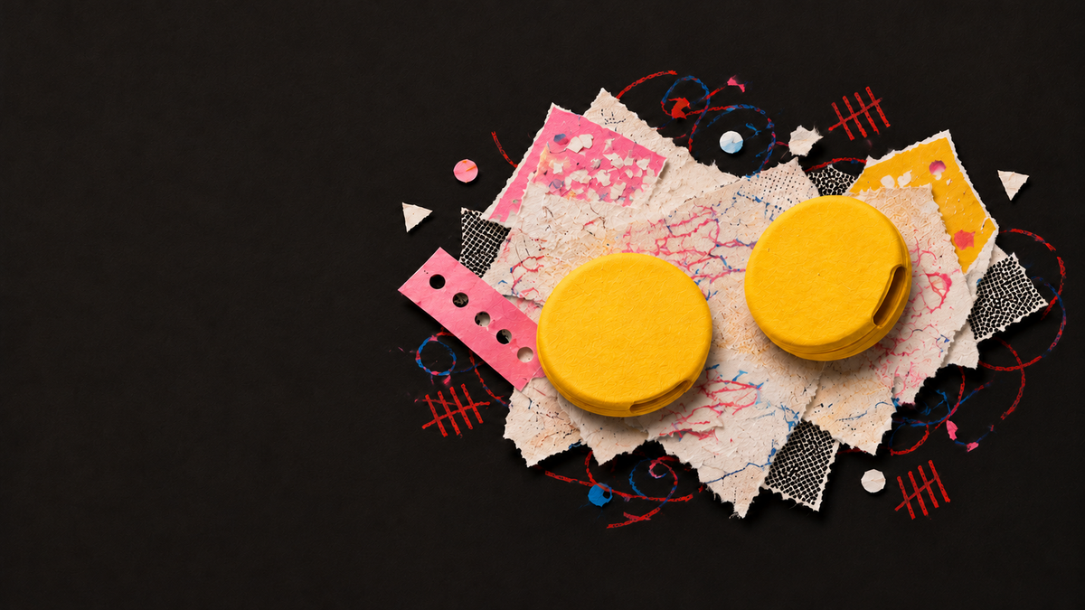 Paper illustration of two round yellow Blips ear grips with small side openings.
