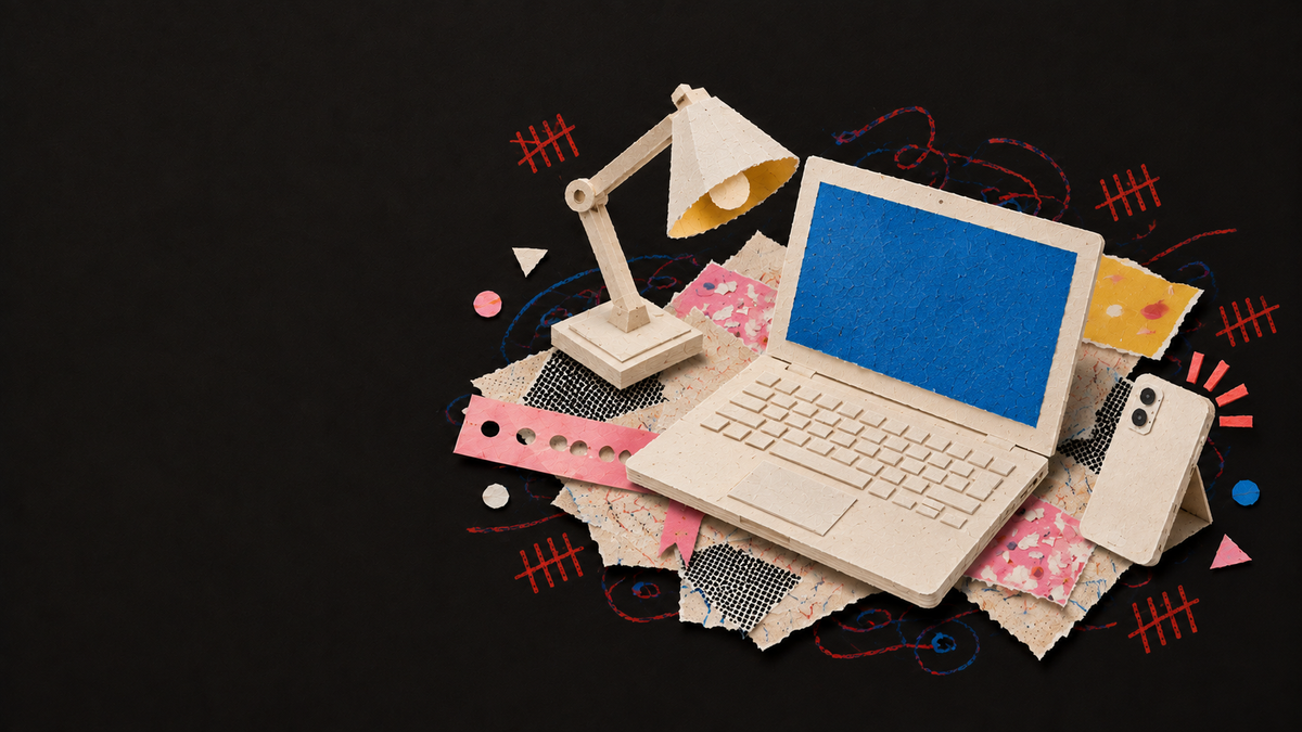 Paper collage of a laptop with a blue screen, a desk lamp and a phone with notification marks.