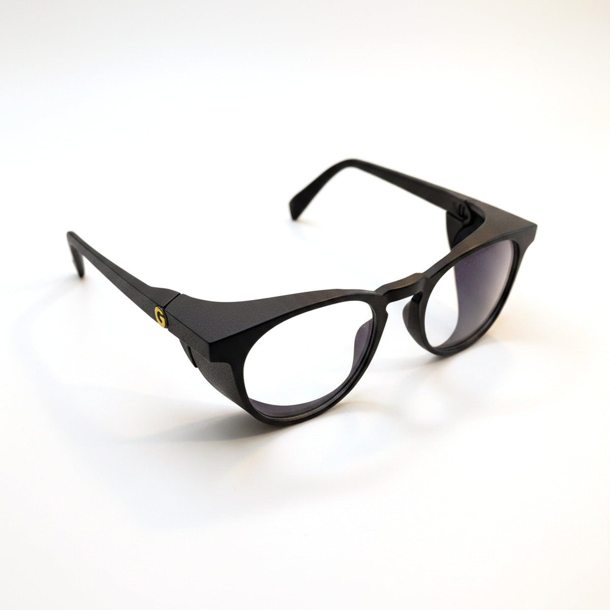 Black Focus Frames in three-quarter view, showing the built-in side shields and yellow hinge detail
